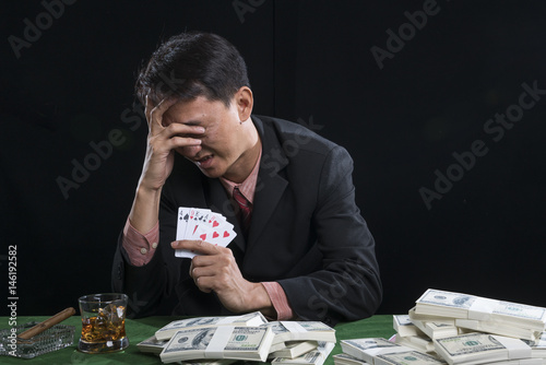 The gambler used a hand off the face with the stress photo