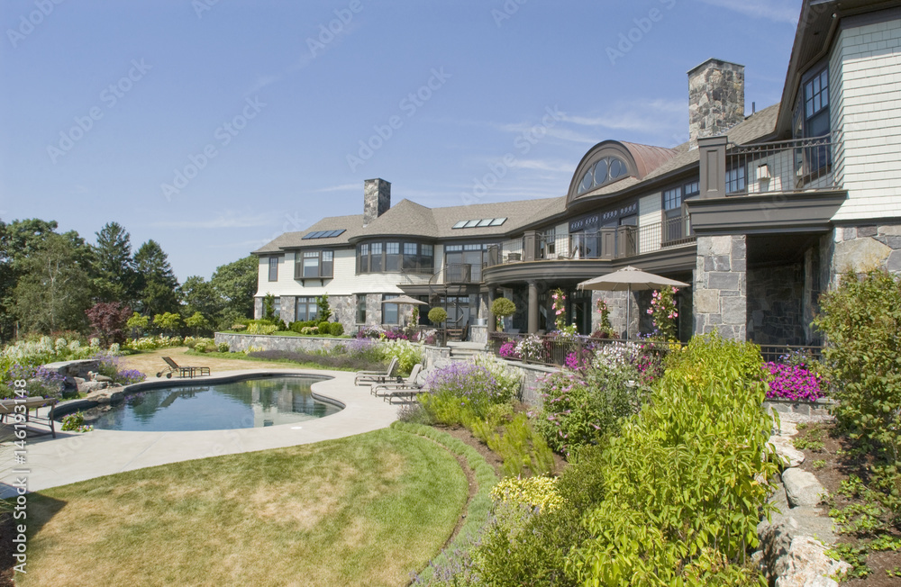 Rear exterior large neo eclectic home with swimming pool Rear exterior large neo eclectic home with swimming pool