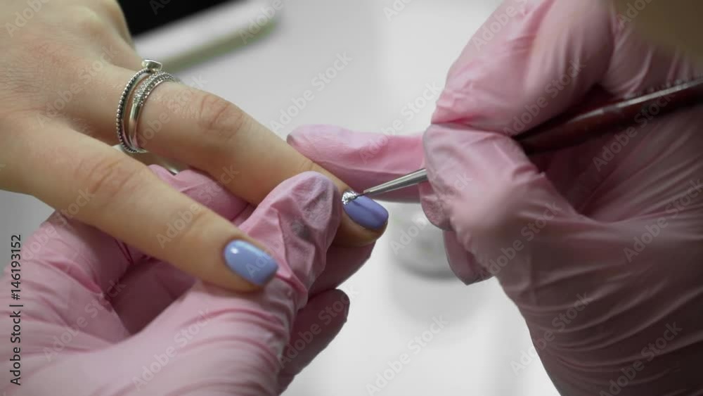 Do a manicure. An unusual beautiful manicure in a beauty salon. Girls paint their nails. Manicure and pedicure. Do a manicure. An unusual beautiful manicure in a beauty salon. Girls paint their nails. Manicure and pedicure.