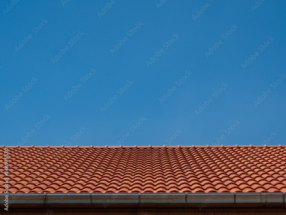 red tile rooftop on blue sky background