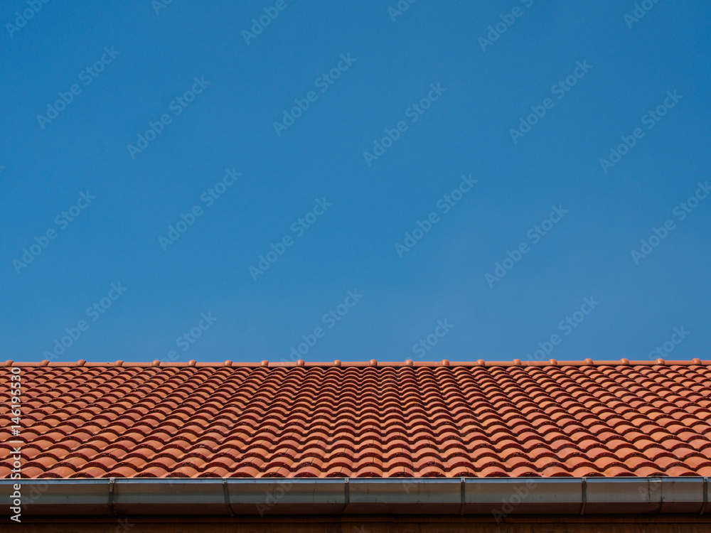 red tile rooftop on blue sky background red tile rooftop on blue sky background