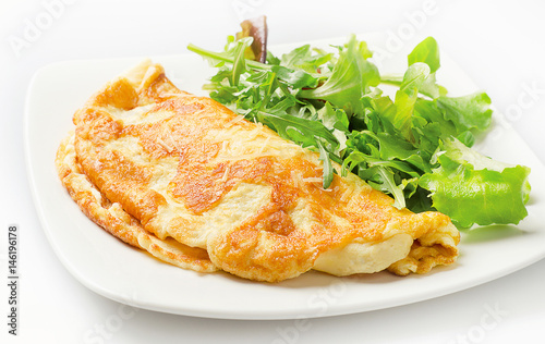 Omelette with fresh salad on white plate photo