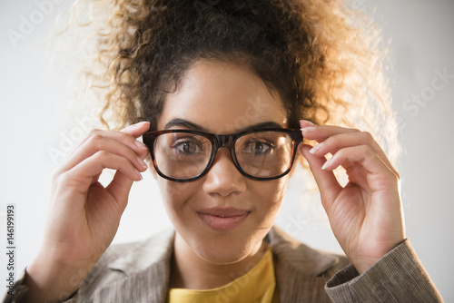 Mixed Race woman adjusting eyeglasses photo