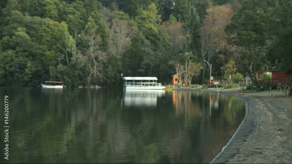 Boats at the shore, small waves and calm water at the beach, makes Calafquén Lake one of best vacation places in Chile. Boats at the shore, small waves and calm water at the beach, makes Calafquén Lake one of best vacation places in Chile.