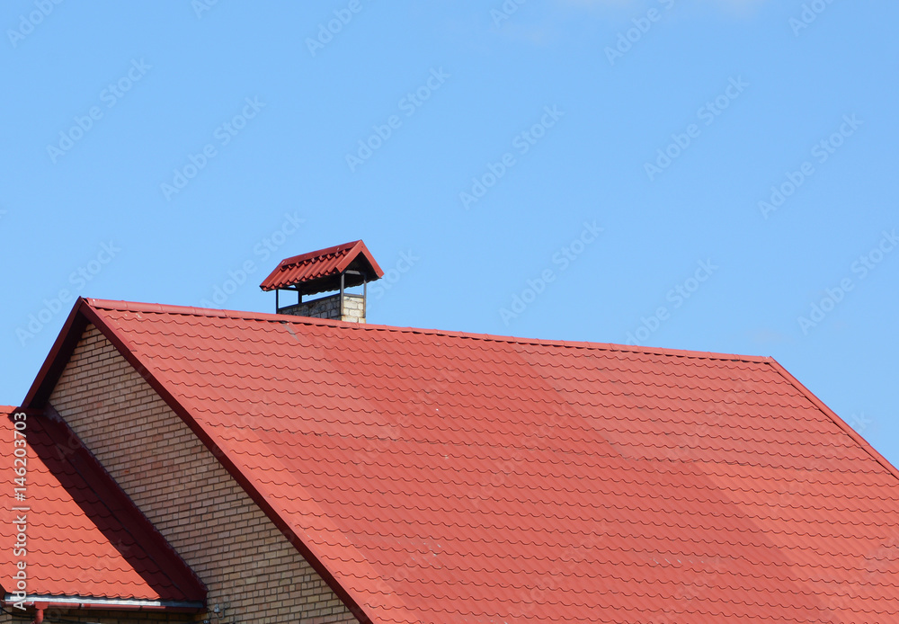New red tiled roof with metal chimney house roofing construction exterior. Roofing construction. Close up on metal roofing 