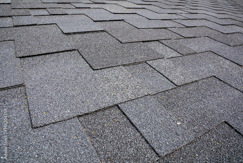 Close up view on Asphalt Roofing Shingles Background. Roof Shingles - Roofing. photo