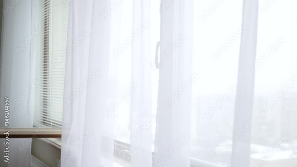 White transparent curtains moving on a draft