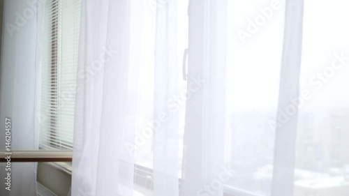 White transparent curtains moving on a draft