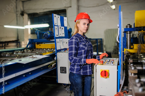 woman in red safety helmet work as industrial worker
