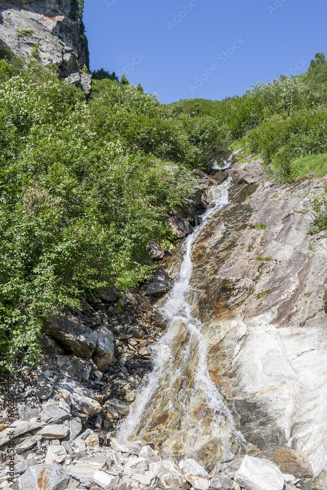 Clear mountain stream and waterfall