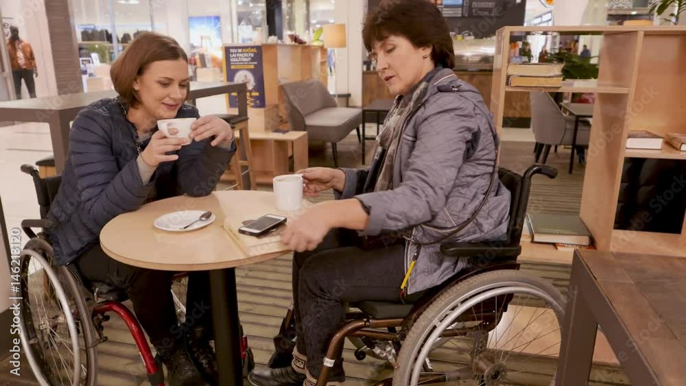 Two physically challenged women in a cafe Two physically challenged women in a cafe