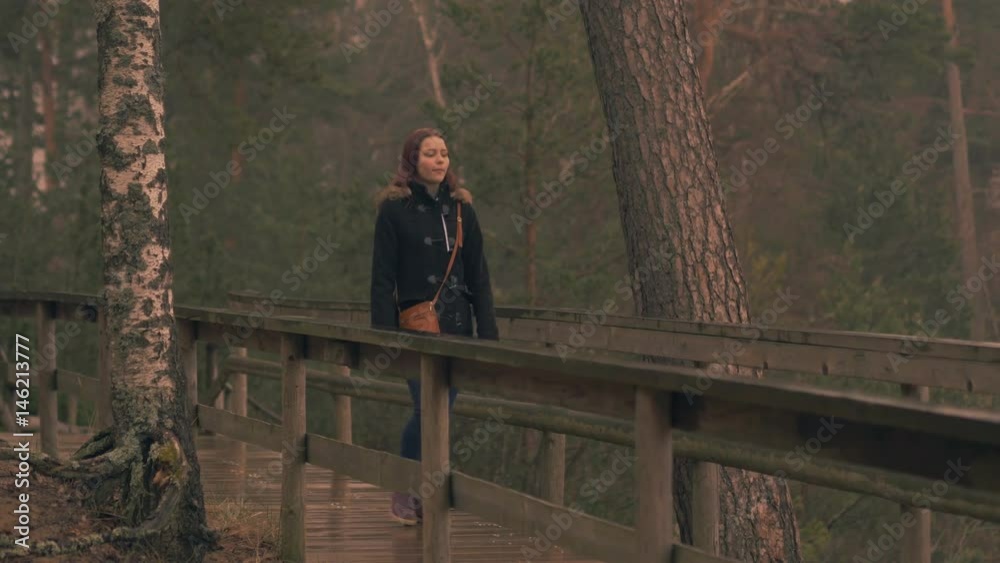 Young girl enjoys rain at sea. 60 to 24fps 4K UHD