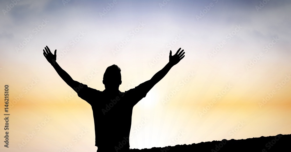 Silhouette man with hands raised against sky