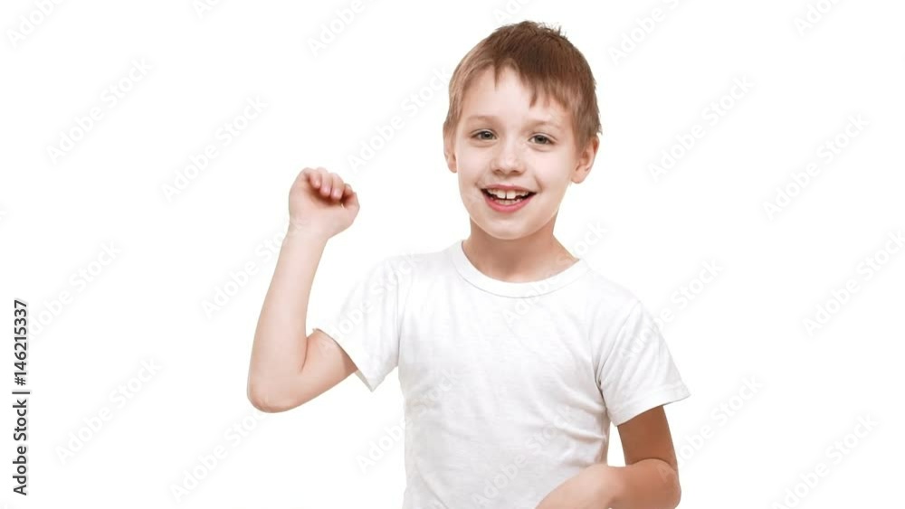Cute elementary-school aged Caucasian boy smiling on white background and waving hands then fading away in slowmotion Cute elementary-school aged Caucasian boy smiling on white background and waving hands then fading away in slowmotion