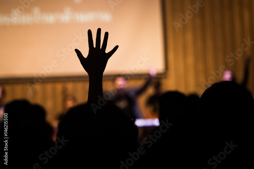 Fototapeta Silhouette people raising hands