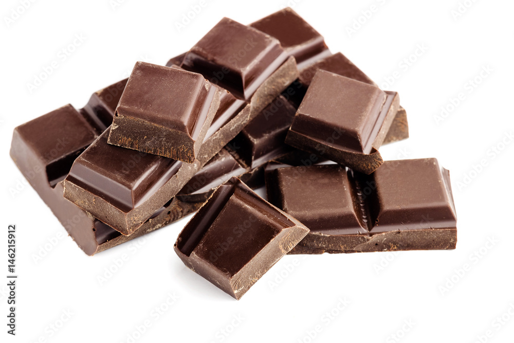 Pieces of bitter, dark chocolate bar, cubes on heap, isolated on white background, close-up view Pieces of bitter, dark chocolate bar, cubes on heap, isolated on white background, close-up view