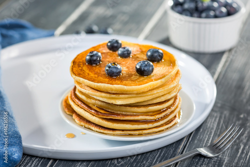 Pancakes  with fresh blueberries and maple syrup, close up
