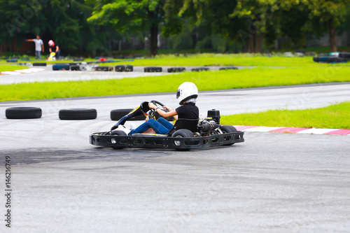 women drive karting car on outdoor track