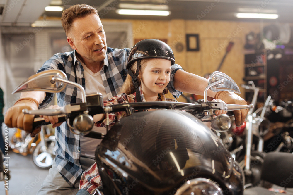 Cute dreamy family sitting on the motorbike Cute dreamy family sitting on the motorbike