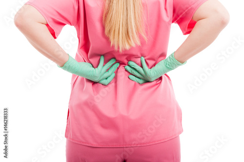 Close-up of female nurse holding back like hurting