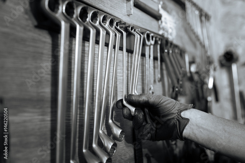 Qualified able specialist choosing a wrench