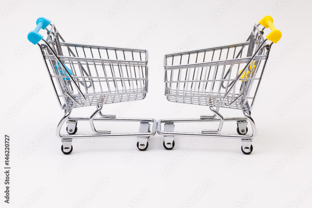 Two shopping trolley on the white desk