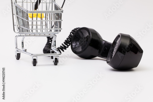 Old phone reciever and cord connection with shopping trolley.