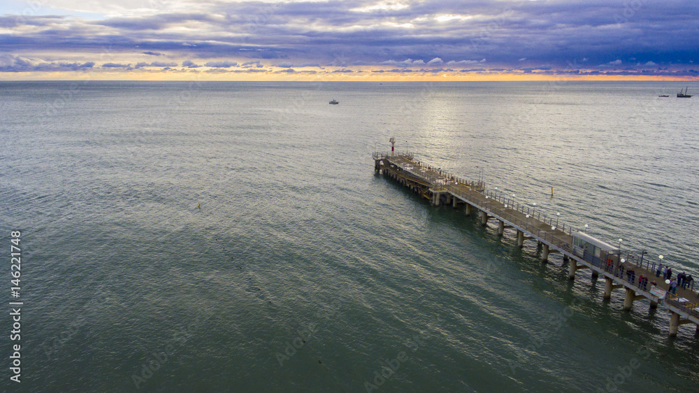 Drone flight over the sea pier with beacon