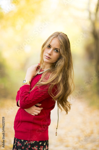 Portrait of a young blonde female on field. Beautiful woman.
