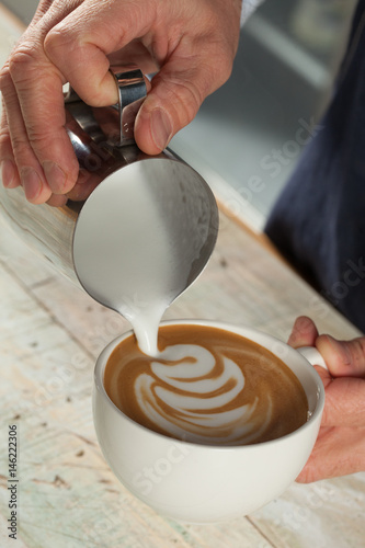 Barista making coffee with latte art