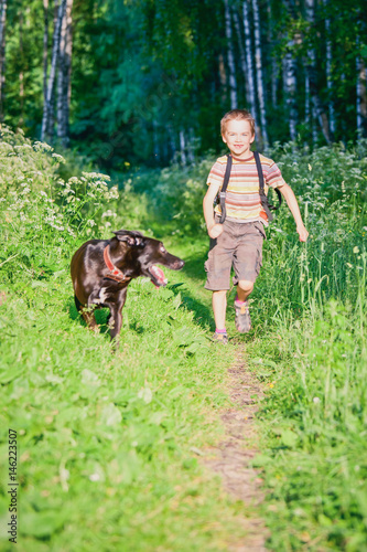 Happy boy running with his dog