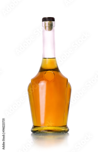 Closed bottle of cognac on white background