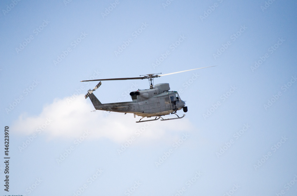Helicopter bell uh 1 approach landing, back right tail side view machine gun