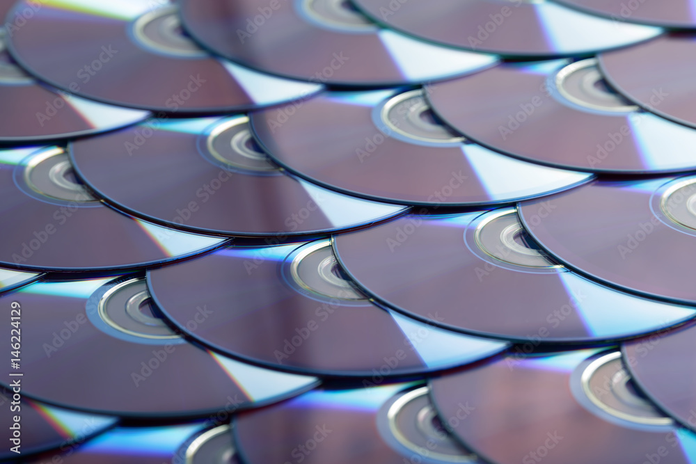 Compact discs background. Several cd dvd blu-ray discs. Optical recordable or rewritable digital data storage. Compact discs background. Several cd dvd blu-ray discs. Optical recordable or rewritable digital data storage.