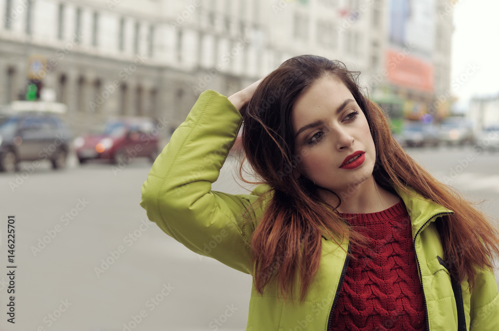 Beautiful girl with long brown hair walks around the city Beautiful girl with long brown hair walks around the city