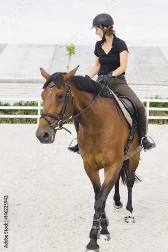 Woman Riding a Horse in Jumper Ring