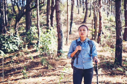 Women hiking in forest and looking for someting in forest.