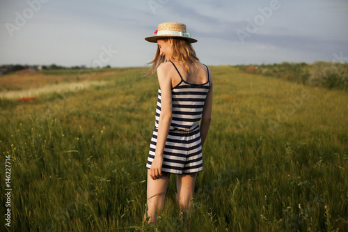 Caucasian woman standing in field of tall grass