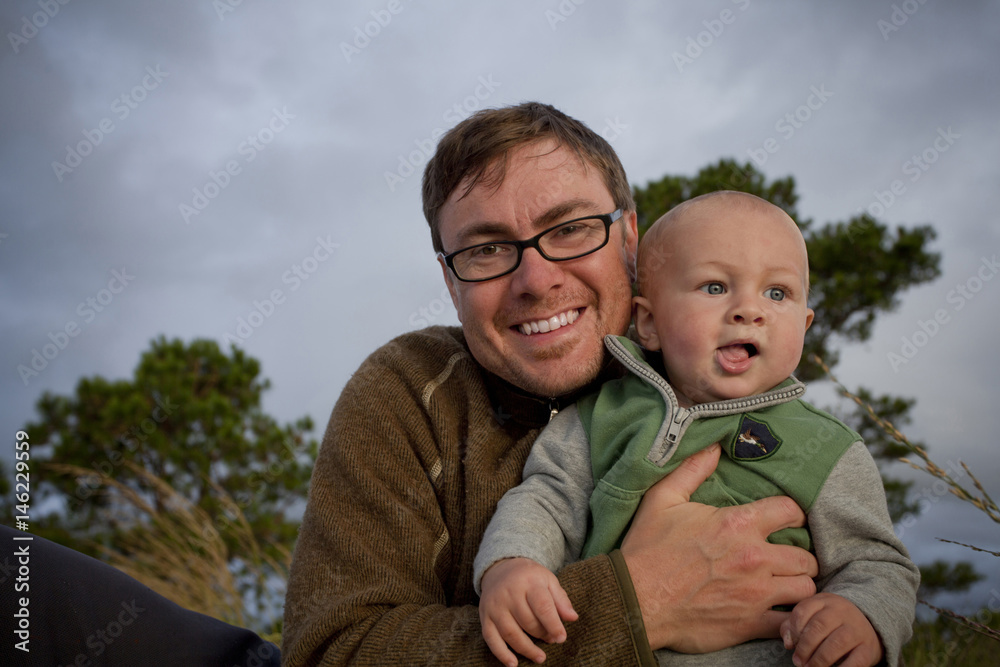 Portrait of smiling Caucasian father holding baby son Portrait of smiling Caucasian father holding baby son