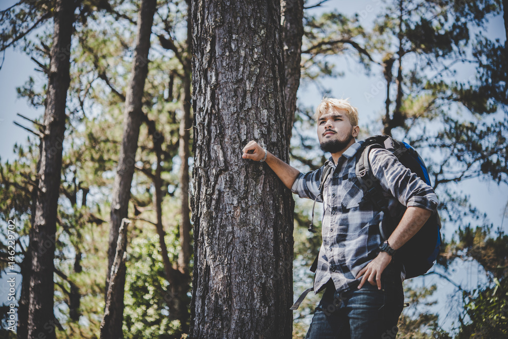 Young man hiking standing relax and admire nature.