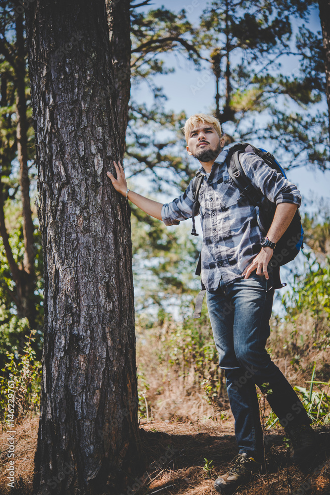 Young man hiking standing relax and admire nature.