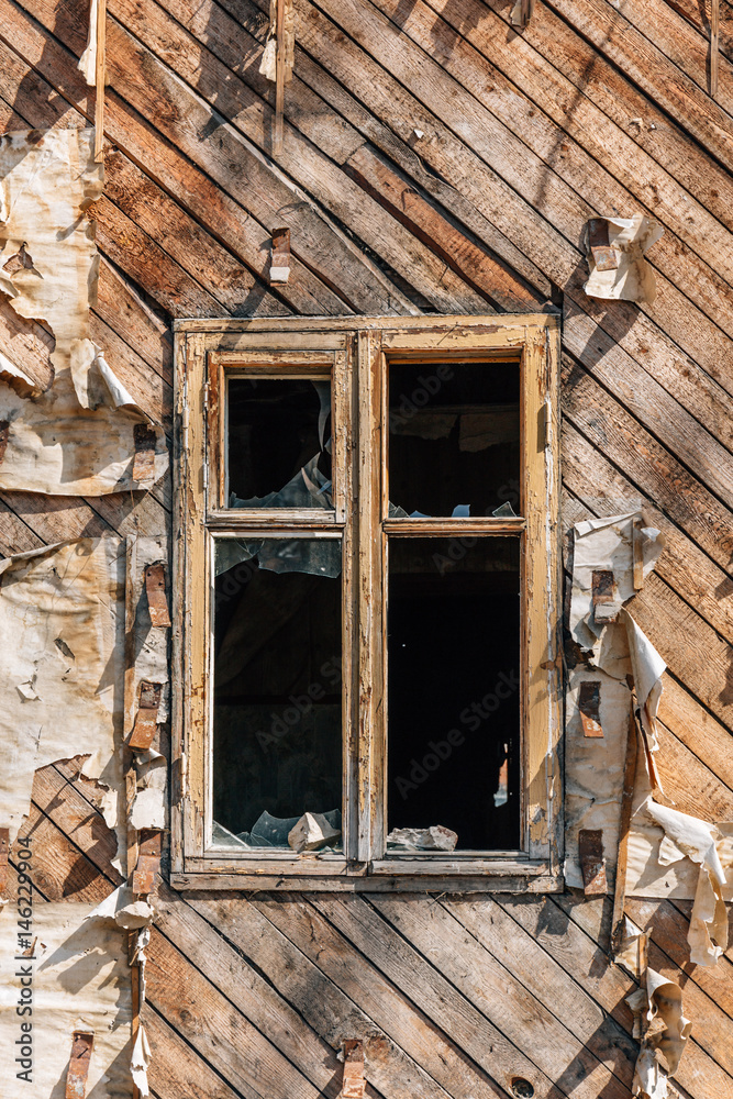 Window with broken glass in a wooden abandoned house Window with broken glass in a wooden abandoned house