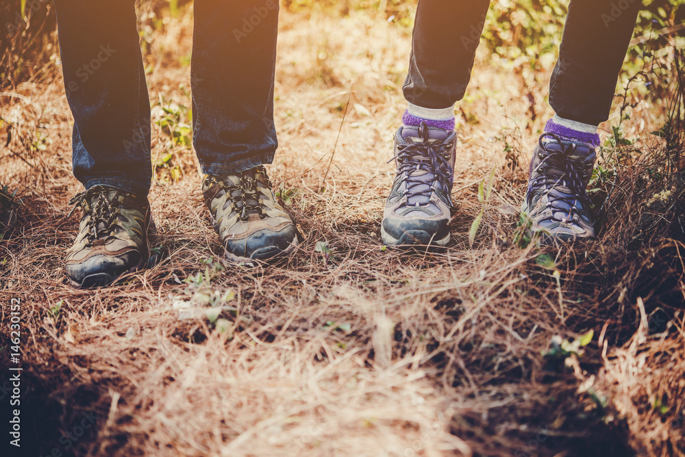 Close-up of legs of  hikers standing on the forset.