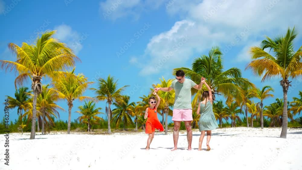 Happy family at tropical beach have fun. Father and little kids enjoy time together on white sand beach on their holiday