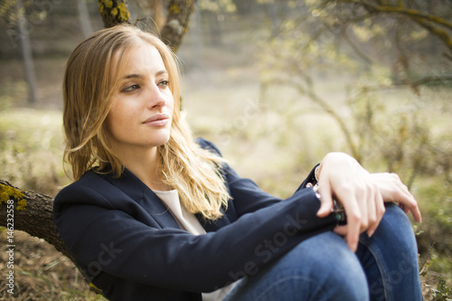 Image of pretty businesswoman looking at camera on natural space