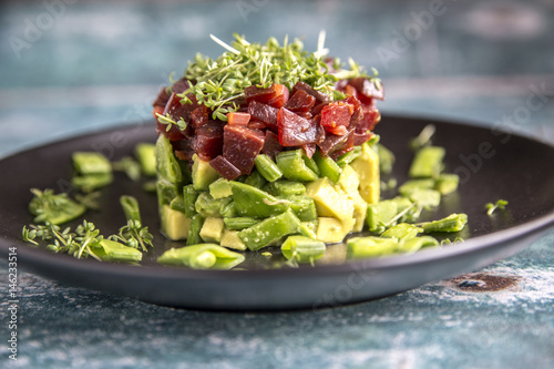 Avocado beetroot salad with snow peas and cress photo