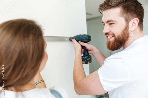 Happy bearded man looking at his woman