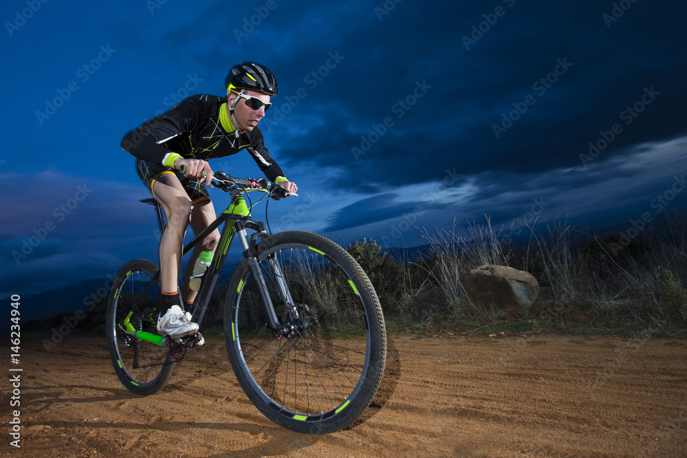 Fototapeta premium Cyclist man riding mountain bike on mountain.