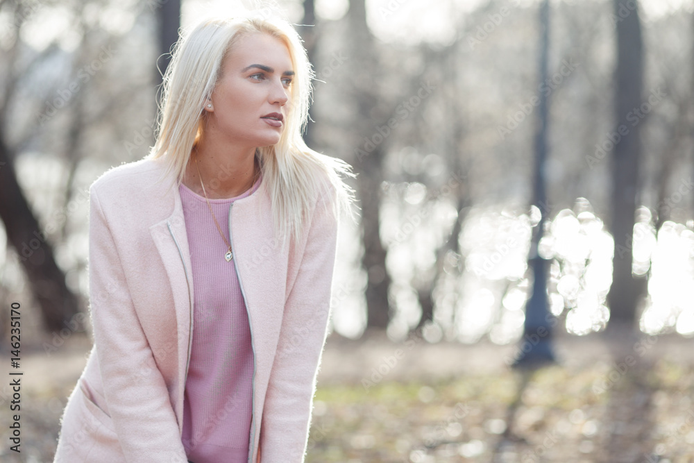 Blonde in coat in woods Blonde in coat in woods