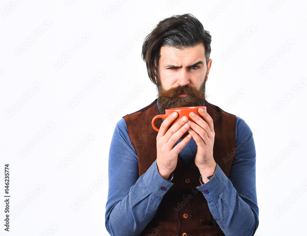 bearded man holding cup with coffee, tea with angry face bearded man holding cup with coffee, tea with angry face